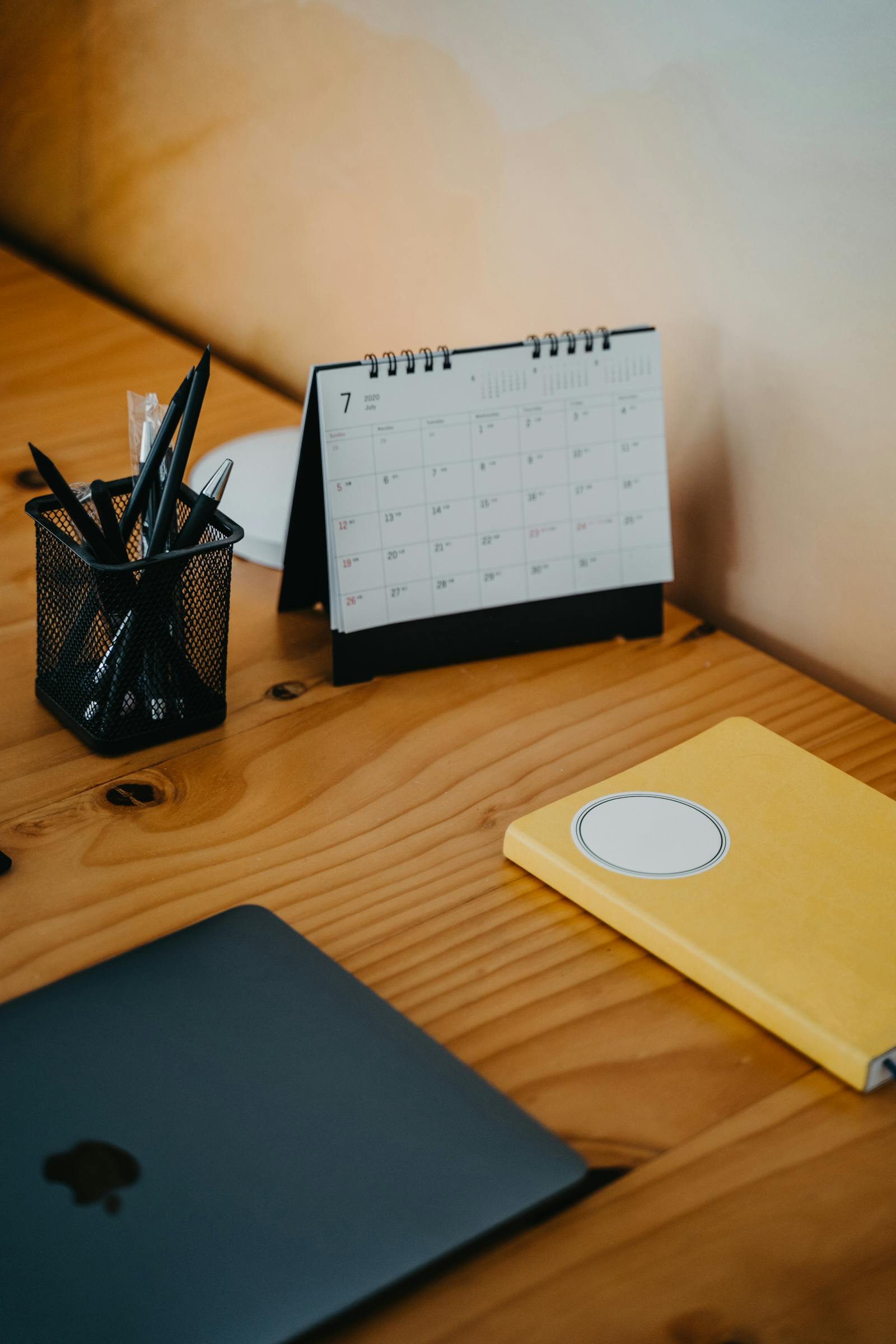 Laptop and calendar used for inbox and scheduling workflow