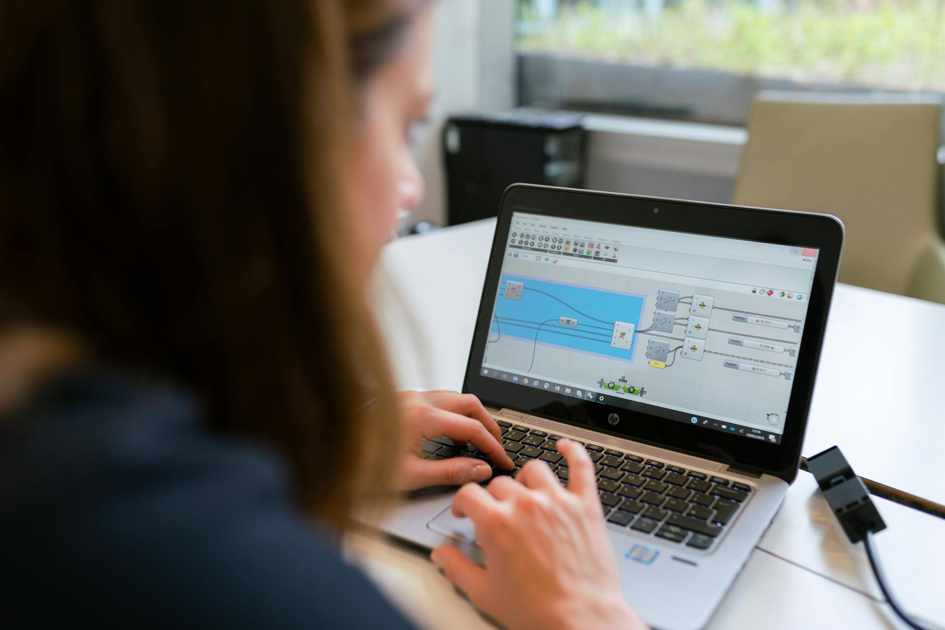 Operator reviewing automation status on a laptop